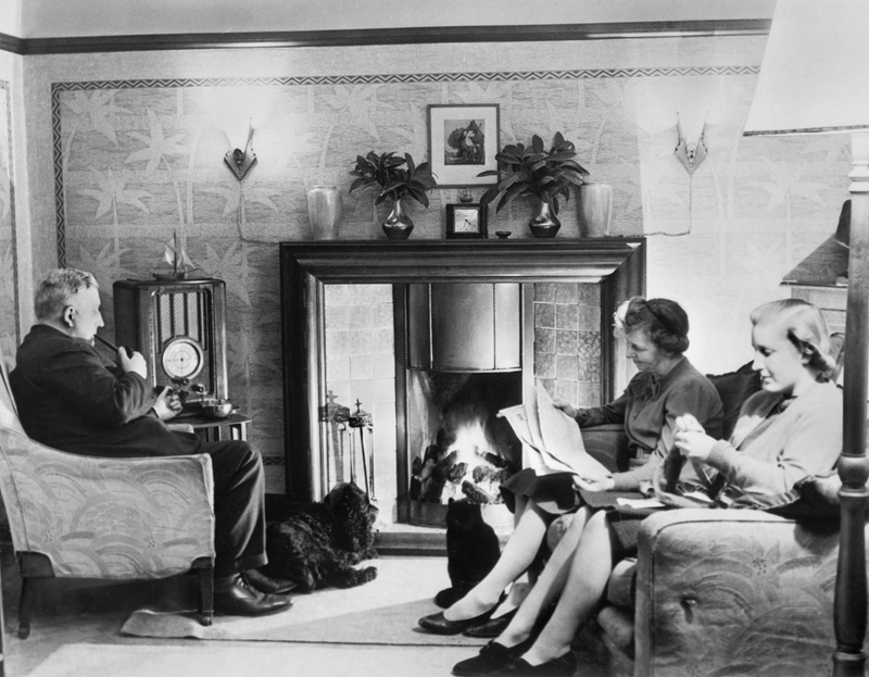 A man and two women occupy themselves with typical wartime leisure pursuits: reading, knitting, and listening to the radio, c. 1942. (Photo: Ministry Of Information Photo Division Photographer/IWM via Getty Images)